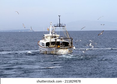 Trawler Fishing Boat Working Along The Coast Of Alicante In Spain