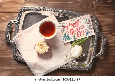 Tray with breakfast and greeting card on wooden background, top view. Mother's day celebration - Powered by Shutterstock