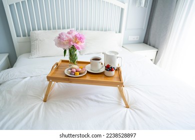 Tray with breakfast on bed.	