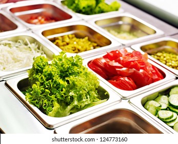 Tray with cooked food on showcase at cafeteria.