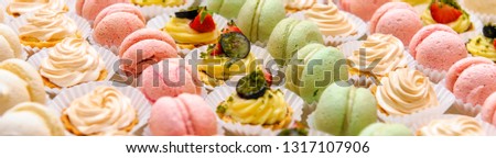 Tray with delicious colorful cakes and macaroon buffet cropped close up image colorful desserts tasty and beautiful, life events, catering restaurant and cafe reception, holiday banquet concept
