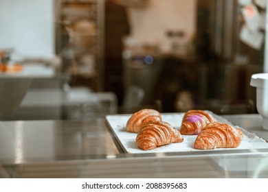 Tray With Delicious Fresh Croissants On Display In Bakery Shop