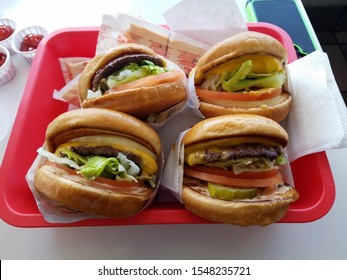 Tray full of four cheeseburgers