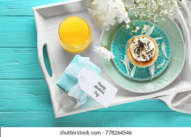 Tray With Gift Box And Tasty Breakfast For Mother's Day On Table