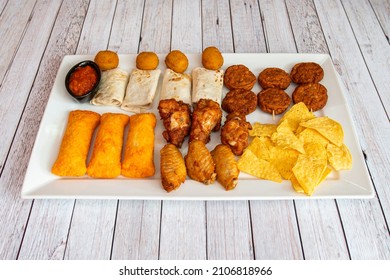 Tray Of Mexican Snacks With Chicken Wings, Tamales, Nachos, Croquettes And Mini Burritos