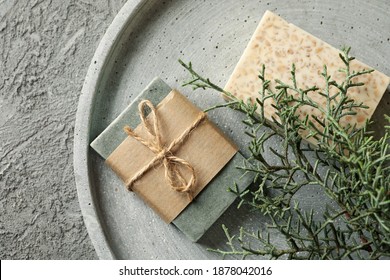 Tray with natural handmade soap on gray background