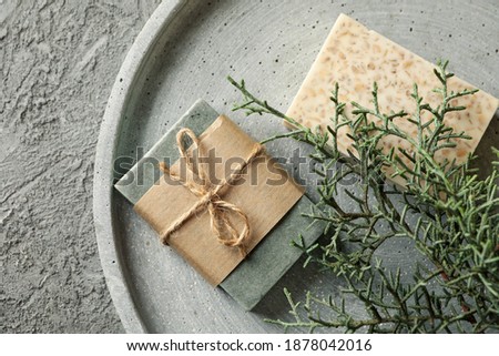 Tray with natural handmade soap on gray background