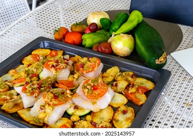 Tray To Put In The Oven With Hake Loins On Potato Slices And A Mince Of Several Vegetables