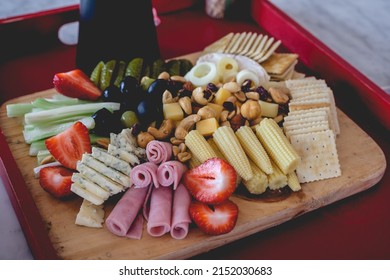 Tray With A Table With Pickles, Celery, Strawberries, Olives, Cheese, Hearts Of Palm, Cookies, Nuts And Ham