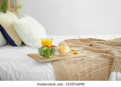 Tray with tasty breakfast on bed - Shutterstock ID 1533714998
