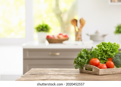 Tray with vegetables on table in modern kitchen