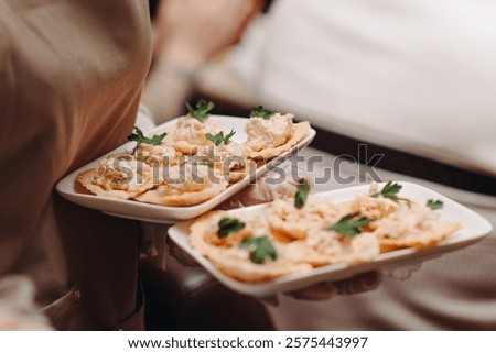 trays of snacks in waitress hands