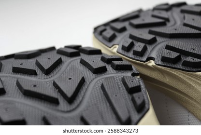 Tread pattern of two rubber soles of hiking shoes close up view 
