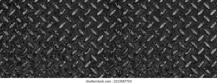 Tread plate, checker plate, diamond plate. Wide dark metal sheet with regular pattern for industrial background texture. Rusty black steel surface with copy space. - Shutterstock ID 2213587753