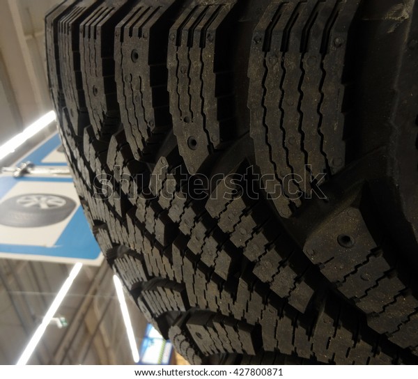Tread and sipes of winter tire at the tires shop\
closeup stock photo