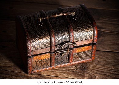 Treasure chest on wooden background