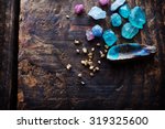 Treasure hunting. Mining for gems. Gold and gems on rough wooden surface.