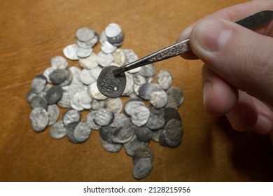 A treasure trove of silver coins from the reign of Ivan 4 the Terrible. Medieval money of Russia in the hands of a collector. Study and attribution of coins. Numismatics, collecting.
