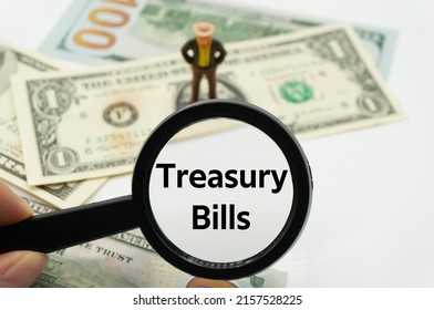 Treasury Bills.Magnifying Glass Showing The Words.Background Of Banknotes And Coins.basic Concepts Of Finance.Business Theme.Financial Terms.