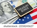 Treasury bonds concept. American flag, dollars and plate.