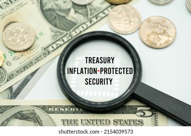 Treasury Inflation-Protected Security.Magnifying glass showing the words.Background of banknotes and coins.basic concepts of finance.Business theme.Financial terms.