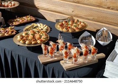 A Treat For A Buffet Or A House Party. The Table Is Reserved For Catering. Black Tablecloths, Hard Light.