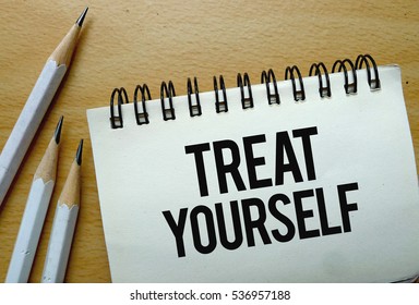 Treat Yourself Text Written On A Notebook With Pencils