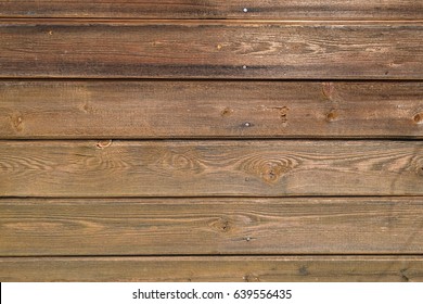 Treated wooden boards - wood decking flooring and wood deck with paneled walls. Textures and patterns of natural wood. Background for interiors and modern design ideas - Shutterstock ID 639556435