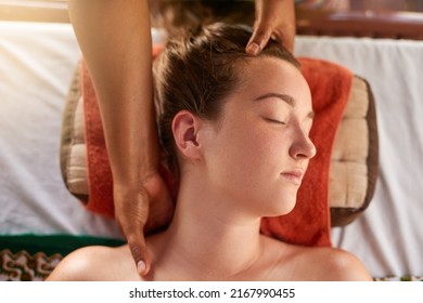 Treating herself to a soothing massage. High angle shot of a young woman getting a relaxing massage at the spa.
