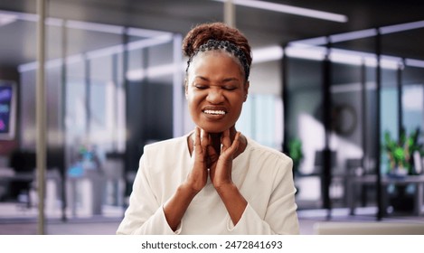 Treating Pharyngeal Throat Cancer: An African American Woman Using Computer for Laryngeal Pain Relief in Isolated Clinic - Powered by Shutterstock