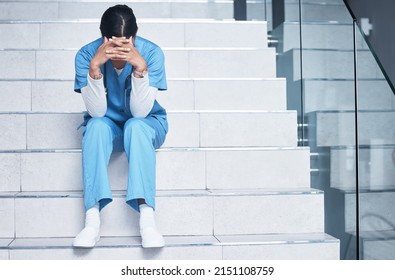 Treating sick people isnt easy and losing them is even harder. Shot of a female nurse looking stressed while sitting on a staircase. - Powered by Shutterstock