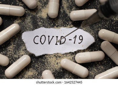 Treatment of coronavirus COVID-19. Infectious virus vaccine. Pills in capsules for treatment. Coronavirus treatment concept COVID-19. The name of the virus is hand written. - Shutterstock ID 1642527445