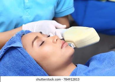 Treatment On Asian Woman As Patient To Make Skin Smooth Bright And Cure Acne With Medical Beauty Device Instrument Cold Process On Face In Hospital Clinic Aesthetics 