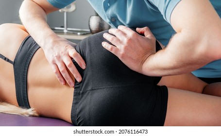Treatment of sacroiliac joint dysfunction (SI joint pain) performed by osteopathic doctor, chiropractor applying manual procedures to lower back region
