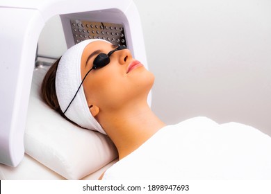 Treatment Of The Skin With Ultraviolet Light. The Girl Lies In The Beautician's Office For The Phototherapy Procedure. LED Lamp Apparatus Photo.