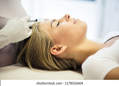  Treatments Of The New Age. Young Woman Doing Face Lifting. Close Up. Copy Space.