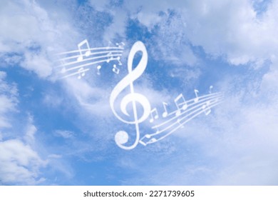 Treble clef and musical notes against sky