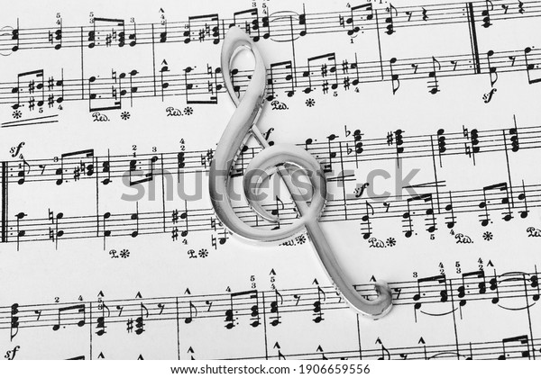 Treble clef\
on music sheet - musical art\
background