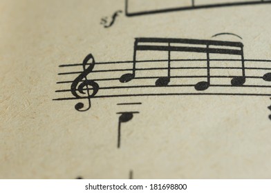 Treble clef and some notes close up on the page