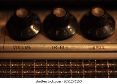 Treble, Volume And Bass Control Knobs On 1960s Vintage Guitar Amp Head. Warm Color Temperature, Shallow Depth Of Field, Macro.