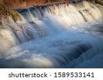 Tree branch in front of time lapse waterfall