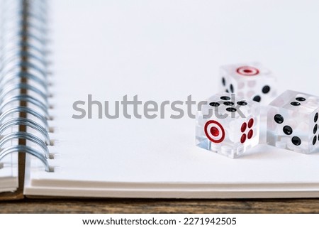 tree dice on white book.