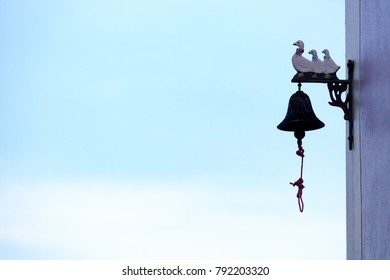 Tree Ducks Toy With Steel Black Bell Hanging On The Top Of The Wall Outside The House And Blue Sky White Clouds