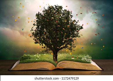 Tree with grass in a beautiful garden on an open book. Learning concept.