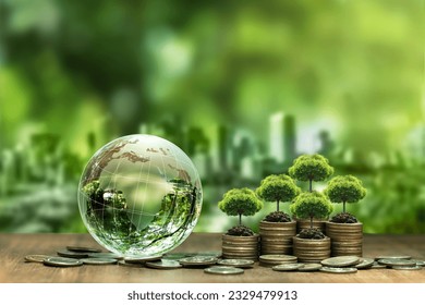 Tree on stack of silver coins and crystal globe Green business concept, finance and investment for sustainability and carbon credit.