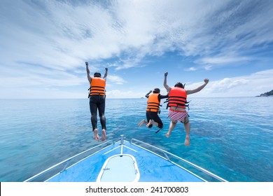 tree people is jumping from speed boat at Ta-chi, Similan Island, Thailand with happiness