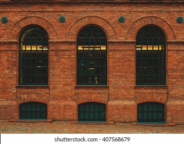 Tree Rounded Vintage Windows On The Factory Red Brick Wall.
