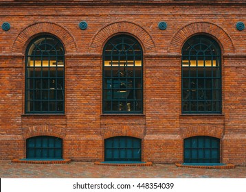 Tree rounded vintage windows on the factory red brick wall.

