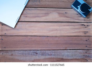 
Tree small , camera and Note Book on desk office wooden 