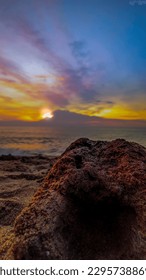 tree trunks, ocean and sunset 